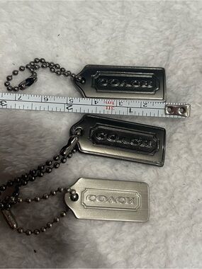 Choice of 1 Coach Silver or Gun Metal Tone Hang Tag Keychains - Small